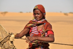 The women do so much of the hard work. Once they pull the water from the well hundred or more feet up from the water level they then carry the water on goats while walking along side for miles back to camps.