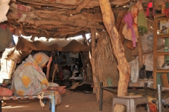 Inside of the hut with intertwined branches there is no stopping the endless wind, heat and dust.