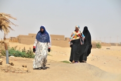 Muslim ladies in the middle of the hot day walking near their village. Ladies take note please.