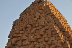 A closeup of the red sandstone bricks that make up the majority of the structure of the pyramids.