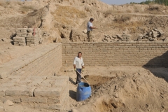 Two workers rebuilding the ruins in the ancient town part of Penjakent.