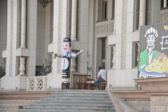 To the left of the doorway street level is a blow up dummy man that waves in the wind with his free hand to enter in to the facility. ome into the restaurant side of the facility.