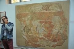 Our local guide in Tajikistan Boz explains what we are looking at. . It is particularly famous for its murals from Penjikent.