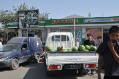 Selling melons from the back of a truck.