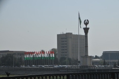 Municipal building with the flag of Tajikistan and flags in the foreground. .