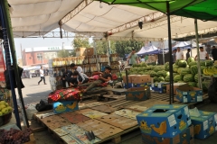 Entering the Panchshanbe Bazaar.  Water melons for sale.  They do not look like they are too interested in selling any. Customers on one side and the sellers taking a break I guess.