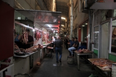 Bill checking out the meat as he walks down the meat section.