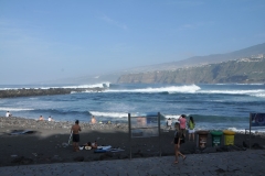 Waves form from a jetty and then make a right angle into the beach area. Lots of rocks on this beach area.