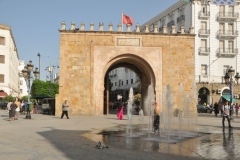 The arch you see in the photo is Bab el Bhar,  gate of the sea, also known as Porte De France , the gate of France,  is a city gate in Tunis, the capital of Tunisia.  It marks the separation between the Medina of Tunis and the modern city. The gate is made up of a lowered archway and topped by a parapet.