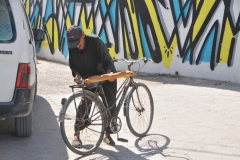 A local stopped for a just baked  bagguete of bread.