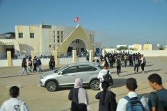 Driving through a local town we find high school students going to classes. 