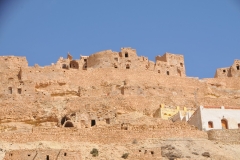 The clever construction of Chenini was clever construction in that its rock shields the homes from wind and extreme temperatures of heat. The houses are built by digging deep into the horizontal layers of rock. The harder rock serves as the floors and ceilings of these houses.  