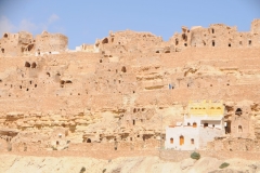 Lady in blue walking within the hillside