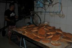 Bread purchased daily is a staple in Algerian and Tunisian daily life.  Here you can see bread just out of the oven.  Still prepared for centuries in the same manner. 