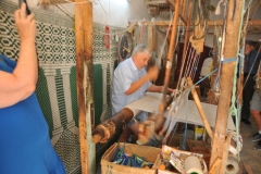 Carpet making  on a hand loom.  For centuries this has not changed. 