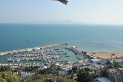 Sidi Bou Said is a town in northern Tunisia located about 12 miles from the capital, Tunis.  The town itself is a tourist attraction and is known for its extensive use of blue and white. Sidi Bou Said has a reputation as a town of artists. Below you can see the harbor and the beaches. 