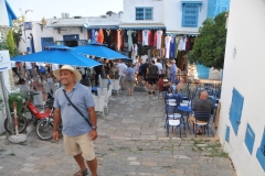 Mohamed standing among many of the souvenir shops close by.