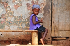 A young boy, most likely a son of the  guards or staff living in this building . Not the best of living conditions for sure.
