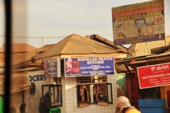 A small by the road butcher shop where products are hung out in the sun daily until sold.