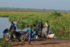 Locals waiting to go aboard a canoe to another village close by in the wetlands
