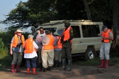 Our group putting on life vests for our journey by canoe in the wetlands.
