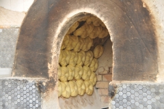 Every day, Uzbek bakers hand-roll and stamp thousands of  loaves of bread. Shaped like wheels, these loaves are dense and chewy, with a golden crust and an airy crumb.  They're often eaten in groups and shared around the dinner table. While you can find countless varieties of these breads across Uzbekistan, the most legendary loaves are baked in the city of Samarkand which we will visit in a few days. Here, bread is sacred and made with the utmost care.