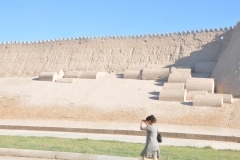 The semi round cement, laid on the smooth parts of the wall,  are actually burials of those that were killed on that very spot defending Khiva through its history.