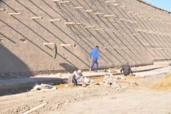 Inside the wall within the city installing new pavers in the streets.