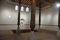 Inside a mosque with the walls of the old city. Note the wooden pilars