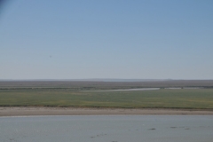 After our break stop we travel for hours through the Kyzyl-kum Desert.  In the distance we see the border of Turkmenistan.