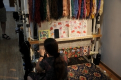 Workers, from outside the city, making the Bukjara rugs for sale.