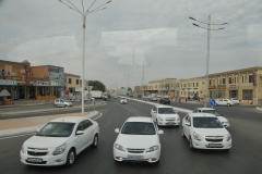 Driving around Bukhara.  Funny all the cars in the photo are white in color.