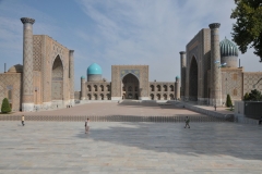 Along with Bukhara, Samarkand is one of the oldest inhabited cities in Central Asia, prospering from its location on the trade route between China and Europe.  Samarkand's earliest dates of the city's founding is believed to be the 8th–7th centuries BC.  The buildings seen in the photo are Registan Square. Registan was a public square, where people gathered to hear royal proclamations, heralded by blasts on enormous copper pipes called dzharchis - and a place of public executions. It is framed by three madrasahs, Islamic schools, of distinctive Islamic architecture.