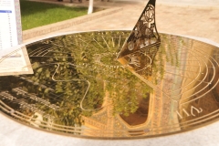 Sundial in the courtyard with reflections of the surrounding area